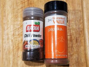 spice containers with Mexican chili powder and paprika